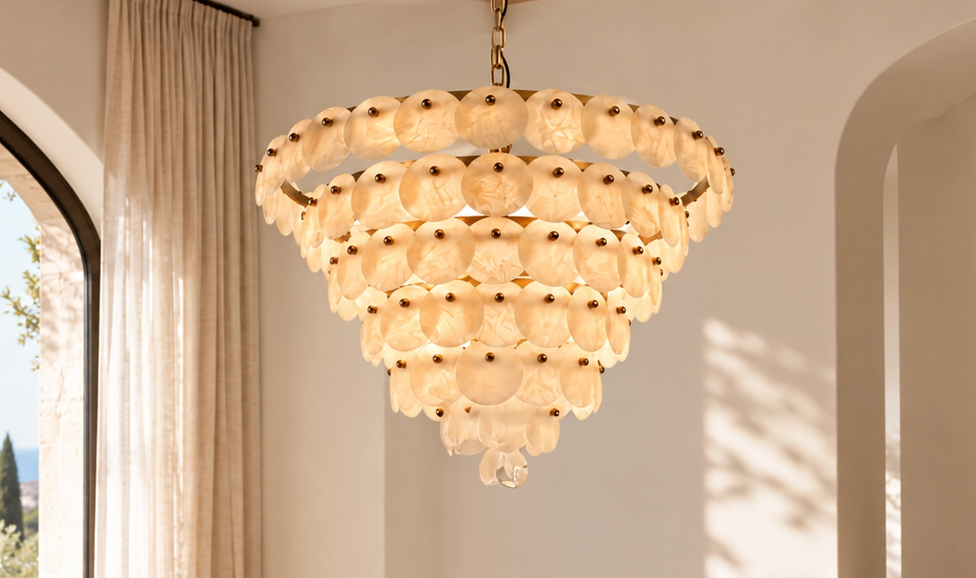 Tiered textured glass chandelier with brass frame and exposed bulbs in a room with arched windows